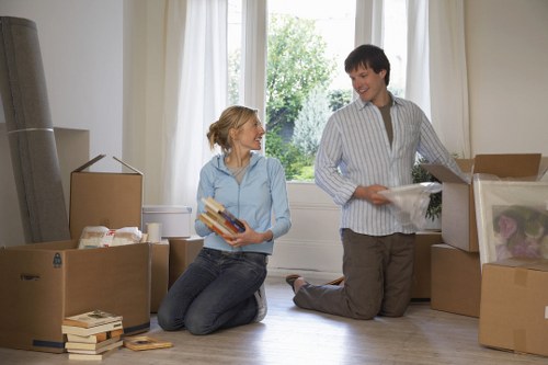 Movers carrying household boxes during a Hammersmith home removal