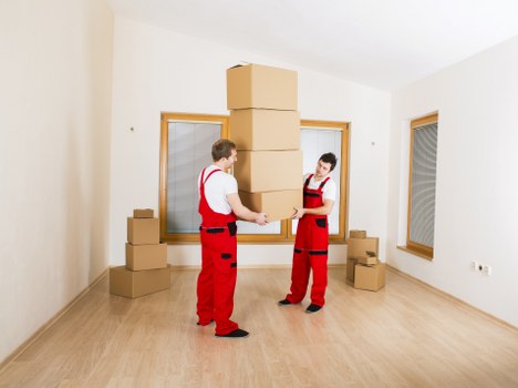Packed moving boxes and furniture ready for collection in a Hammersmith home